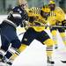 Michigan senior center Kevin Lynch tries to skate past a Notre Dame defender in the second period on Friday. Daniel Brenner I AnnArbor.com
